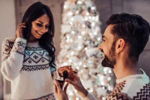 Beautiful Couple Is Waiting For The New Year Together Near Beautiful Christmas Tree At Home.
