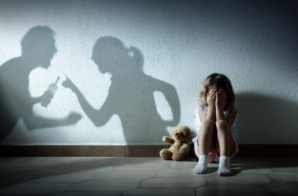 Little Girl Crying With Shadow Of Parents Arguing Home Violenc