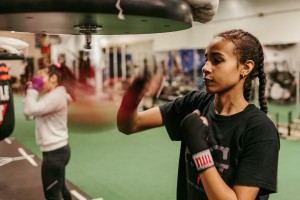 Moragen Ferrell and Brijhana Epperson of Against tha Grain train at their home gym in the back of a low rider auto shop in Independence, MO. Chase Castor for The Pitch.