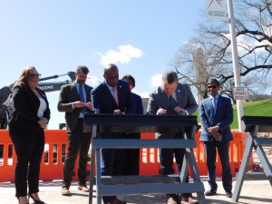 Mayor Lucas and Tom Gerund sign the streetcar track. // Photo by Savannah Hawley