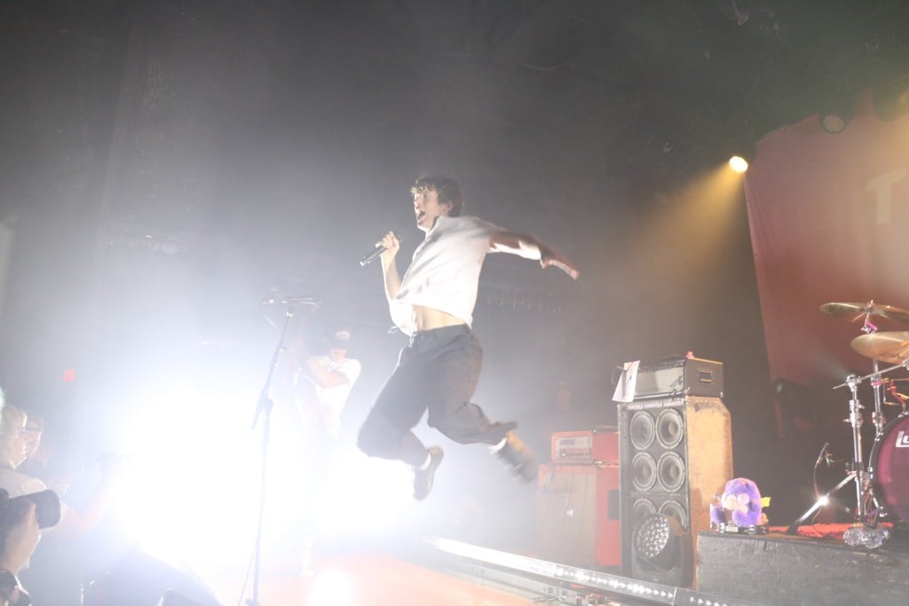 Performer jumping during Turnstile performance.