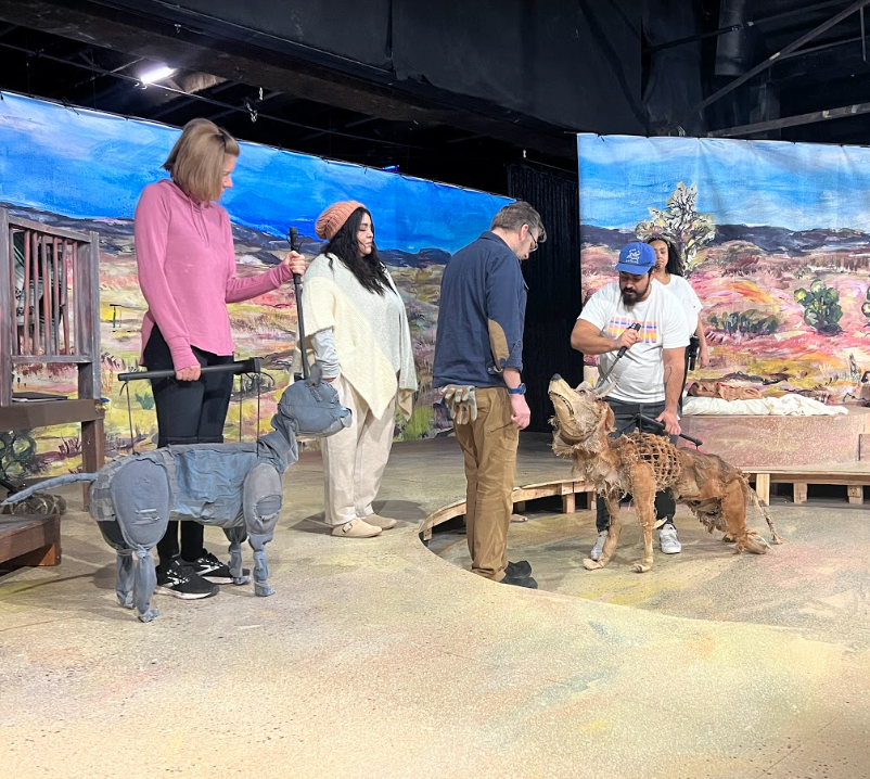 The cast of Refuge rehearse onstage with the rod marionette puppets.