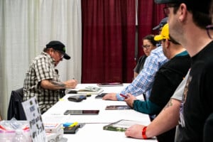 Kevin Eastman, The Creator Of The Teenage Mutant Ninja Turtles, Singing A Fans Notebook At Planet Comicon Kc 2023