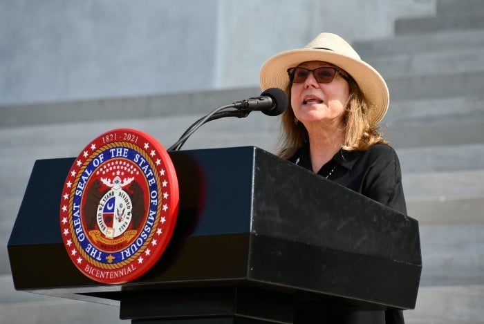 woman speaks at a podium