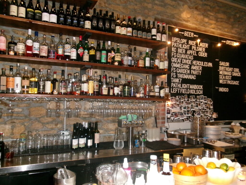 Mass Street Fish House bar, showing a beer list and liquor bottles available.
