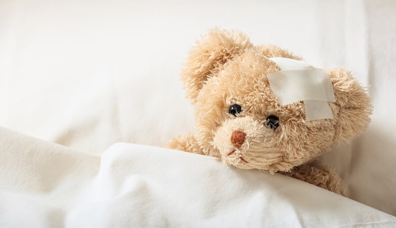 teddy bear with bandaid on head, for article on a pediatric emergency center