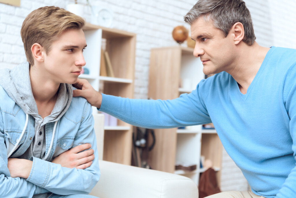 a father talks to his teenage son, for an article on helping kids make good decisions
