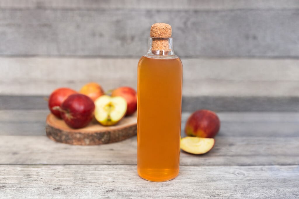 a homemade jar of apple cider vinegar, one of the natural remedies mentioned in this article