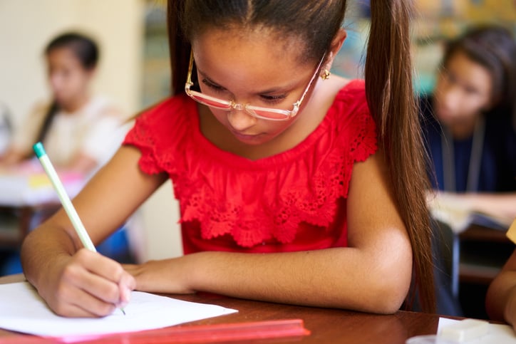 young girl taking test, for article on educational testing