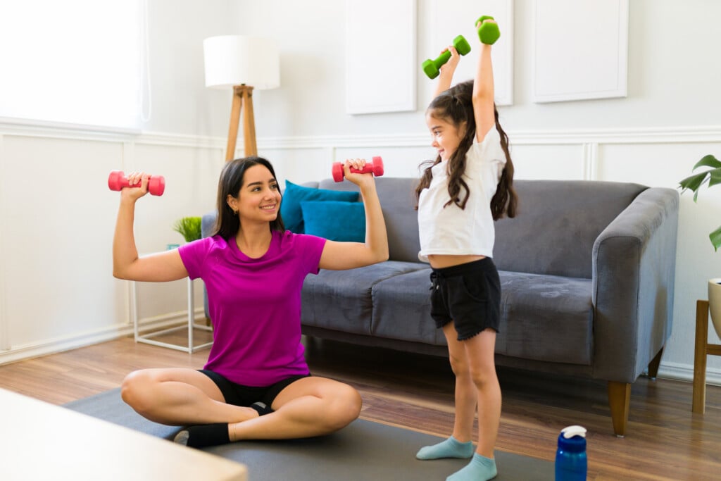 Active Young Mother Doing A Home Workout With Her Litte Kid