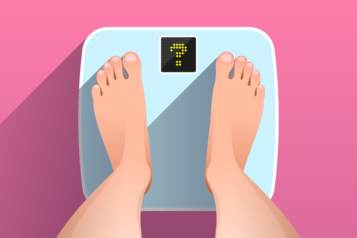 feet standing on a bathroom scale, for article where a mom worries about an overweight daughter