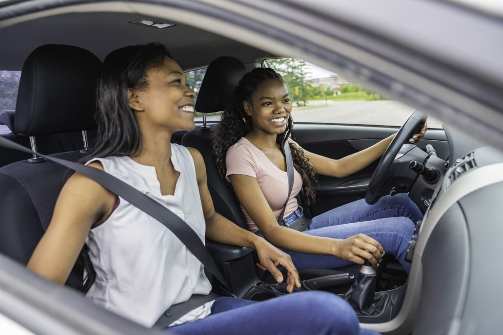 teen girl and her mom in car, with teen driving, for article on drivers ed advice