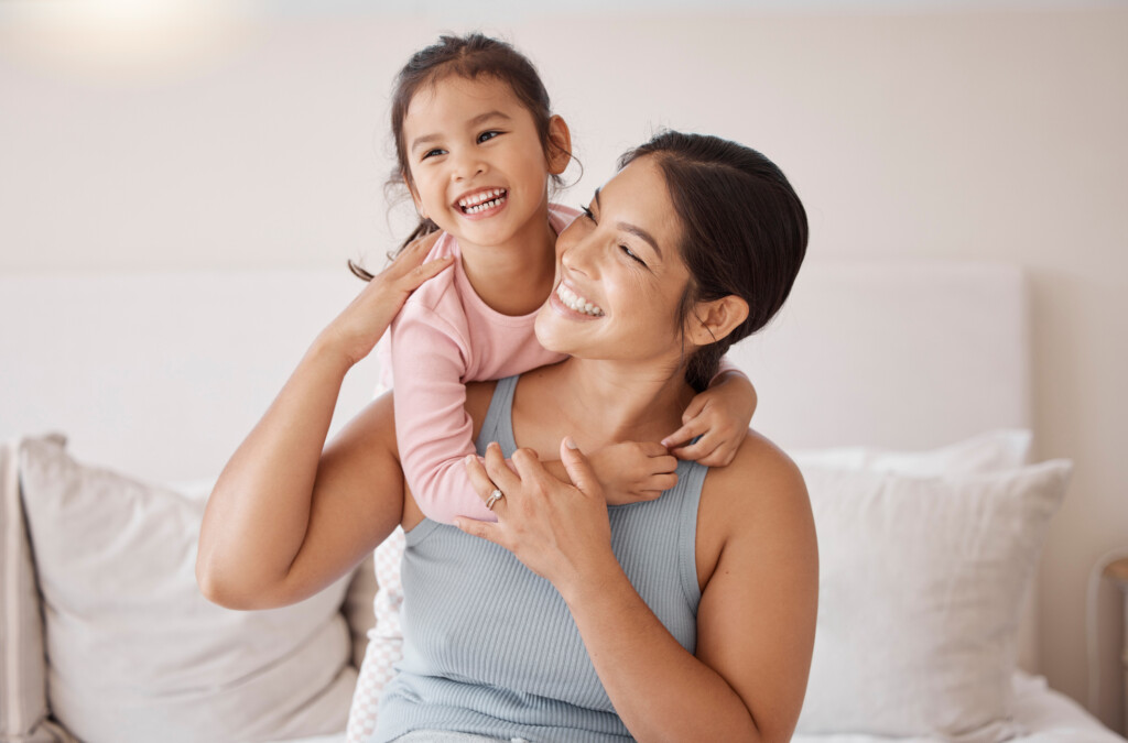 mom smiling at young daughter