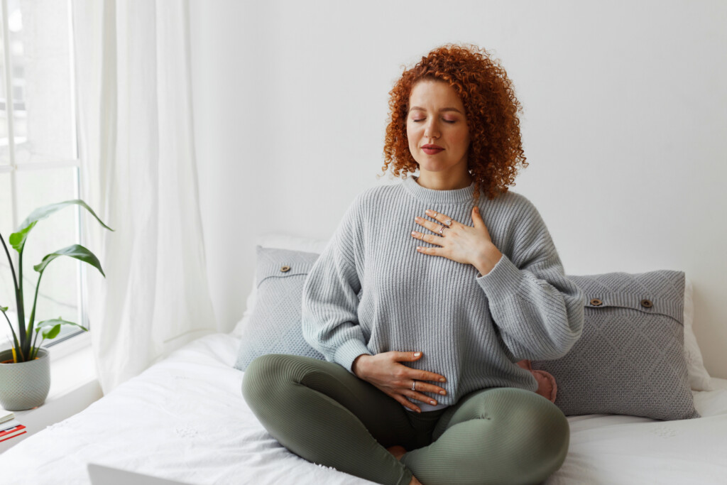 woman meditating in bedroom