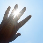 hand in front of hot sun, heat-related illnesses concept