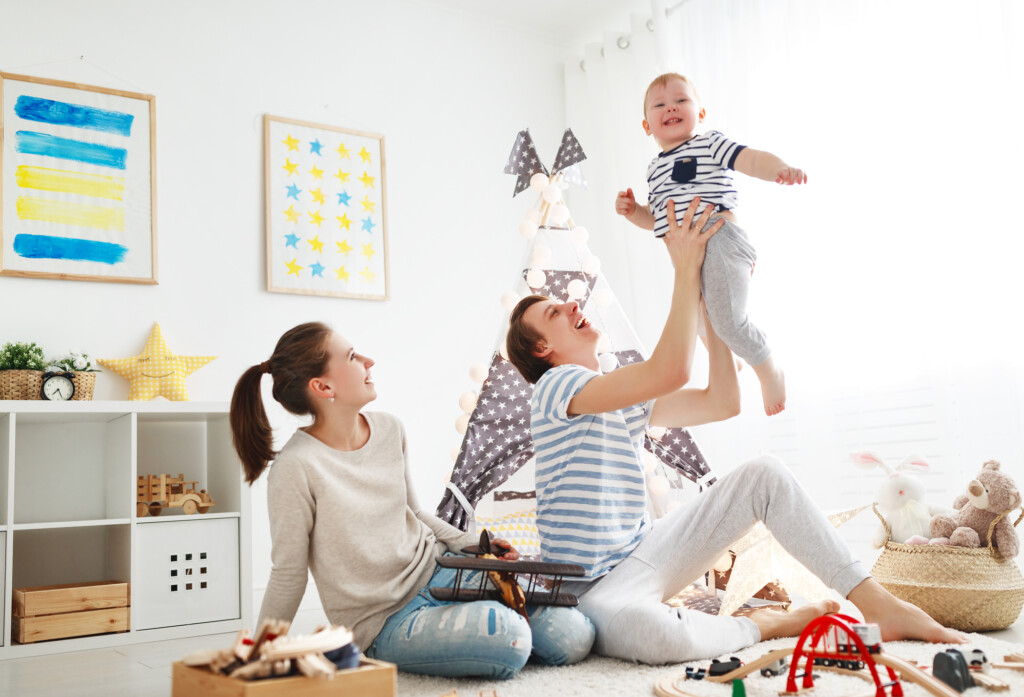 Family Mother Father And Son Playing Together In Children's Playroom