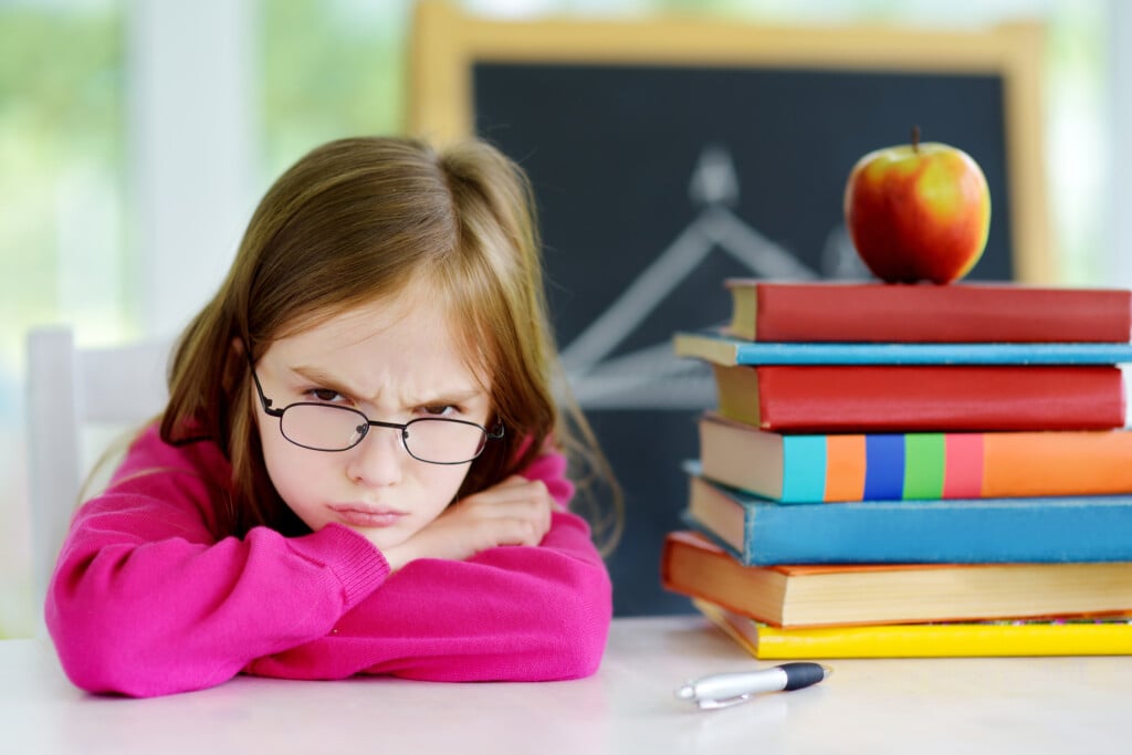 angry girl at school desk