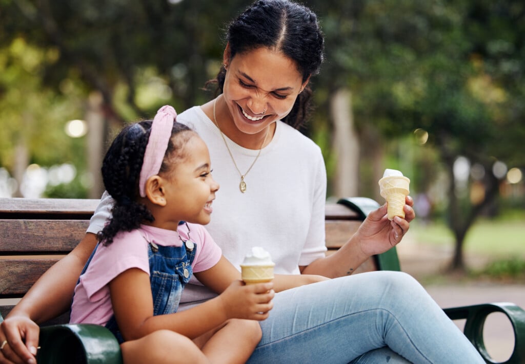 daughter and mom enjoying ice cream in a park, for article on enrichment