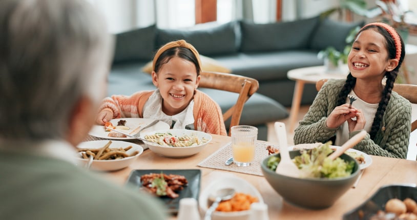 two girls at table for family dinner