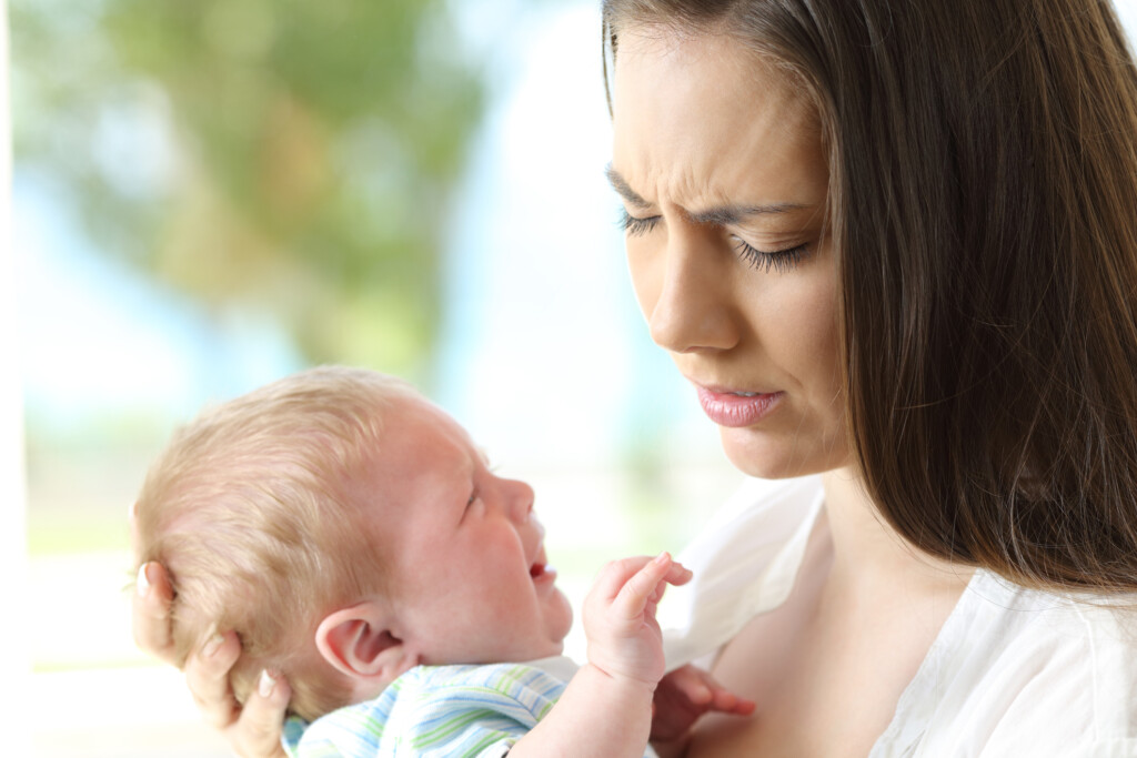 tired mother and crying baby