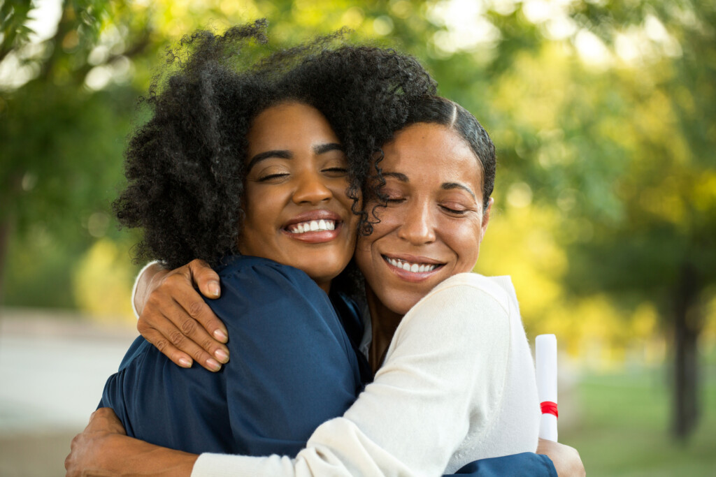 mother and young adult daughter hug, for article about establishing rules for college children