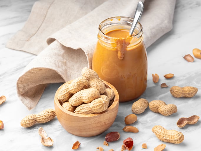 jar of homemade peanut butter and peanuts