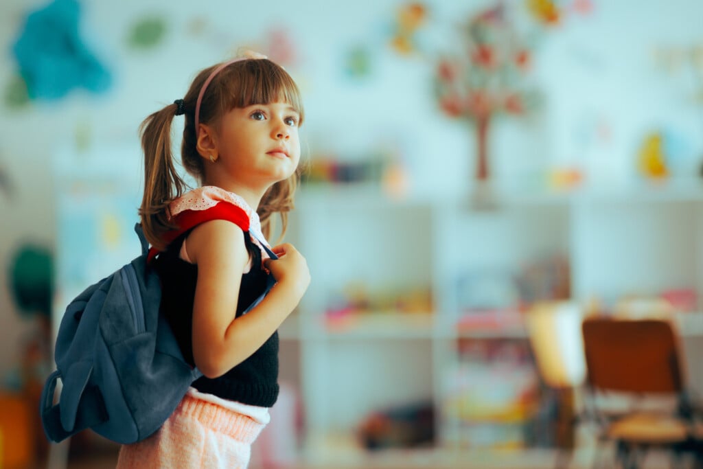 Girl walking into kindergarten classroom