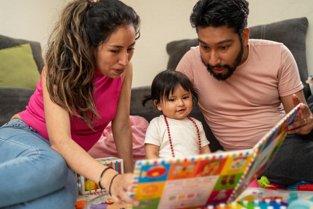 a family reading to their toddler