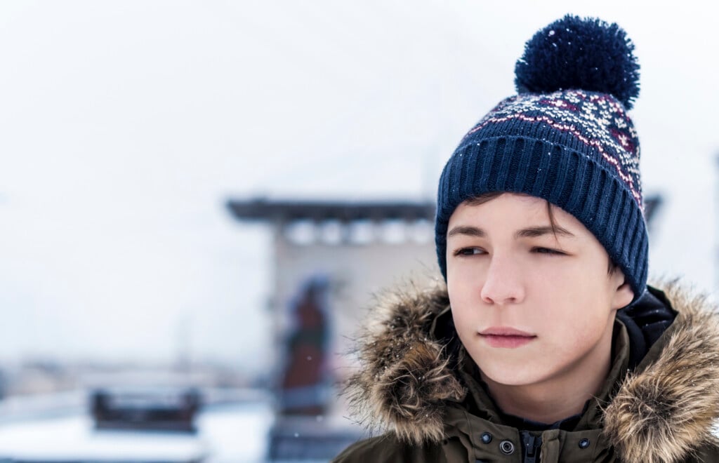 serious looking teen outside in winter