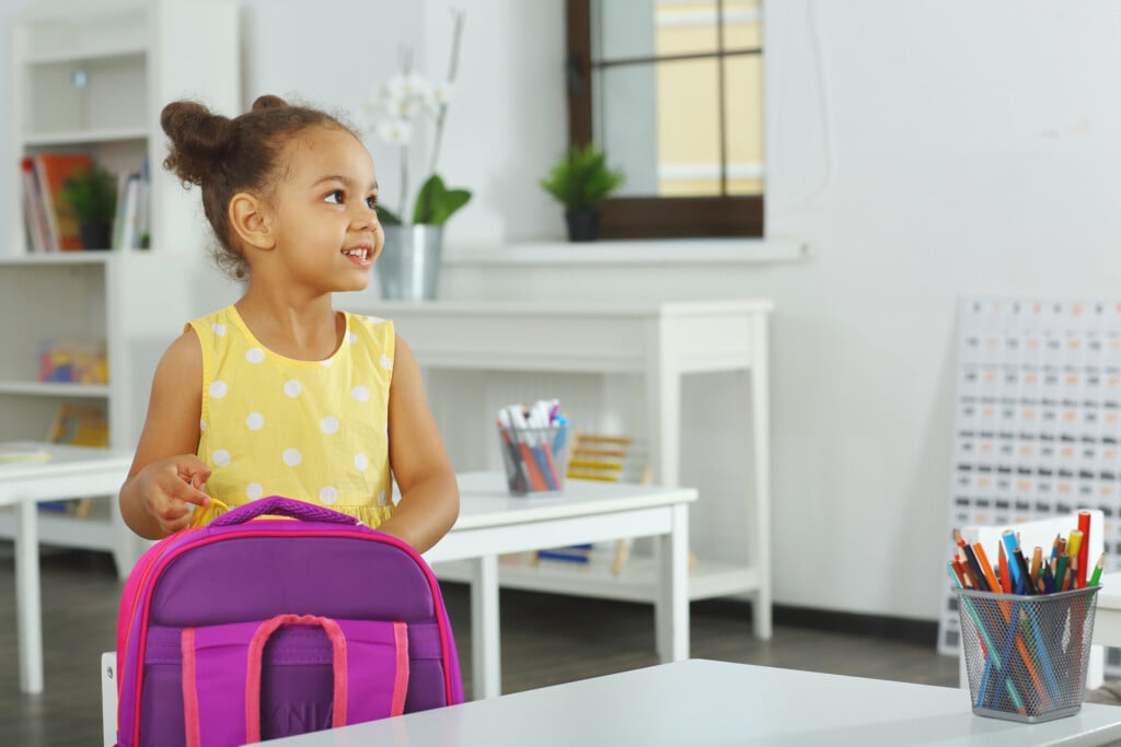 A young girl in a kindergarten classroom
