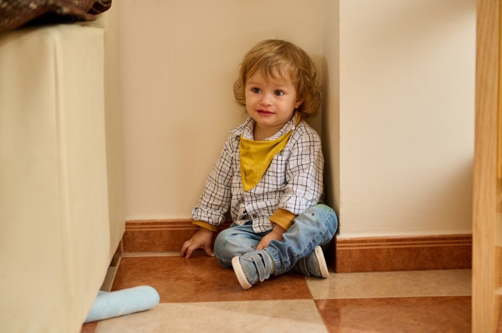 child sitting in corner