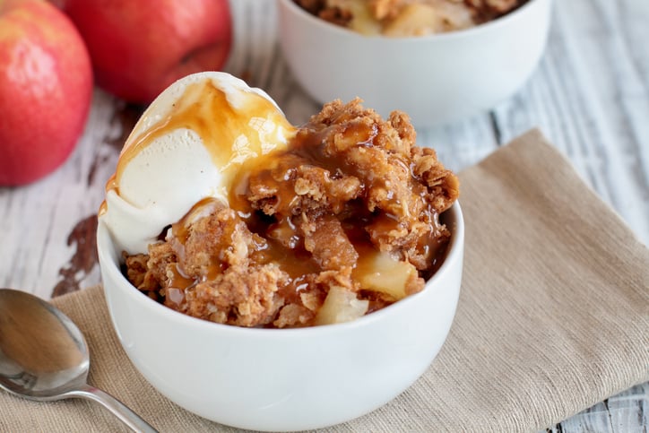 a bowl of apple crisp with ice cream