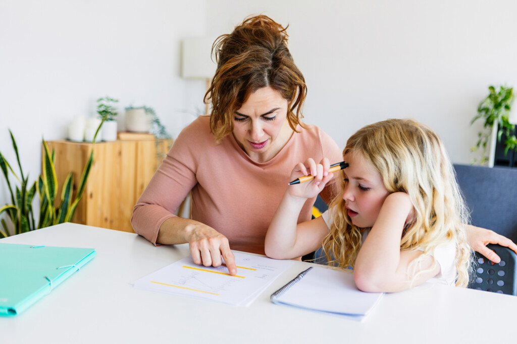 mom and elementary aged daughter doing homework together