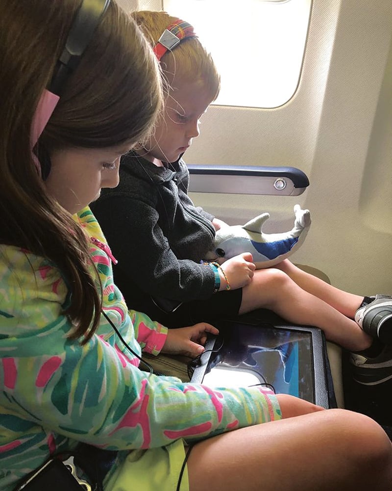 two children on airplane, for article on traveling with kids
