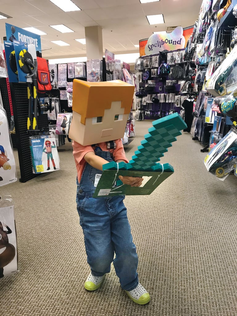 joss in a minecraft costume. minecraft is a popular choice for family gaming