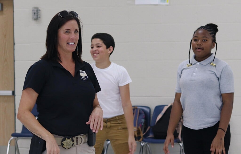 Khara Rogers, Community Relations Officer with Tulsa Police Activities League, works with students in an afterschool program at Monroe Demonstration Academy