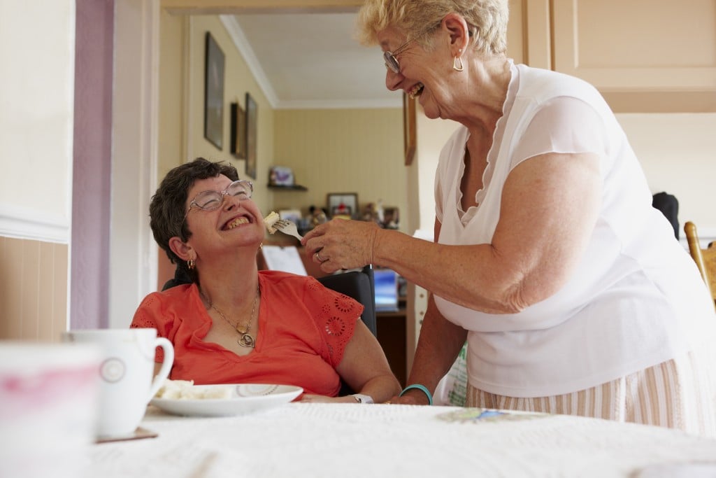 Carer Helping Woman Eat