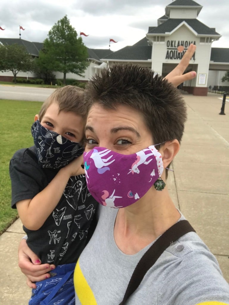 tara rittler and her son wearing masks in front of oklahoma aquarium