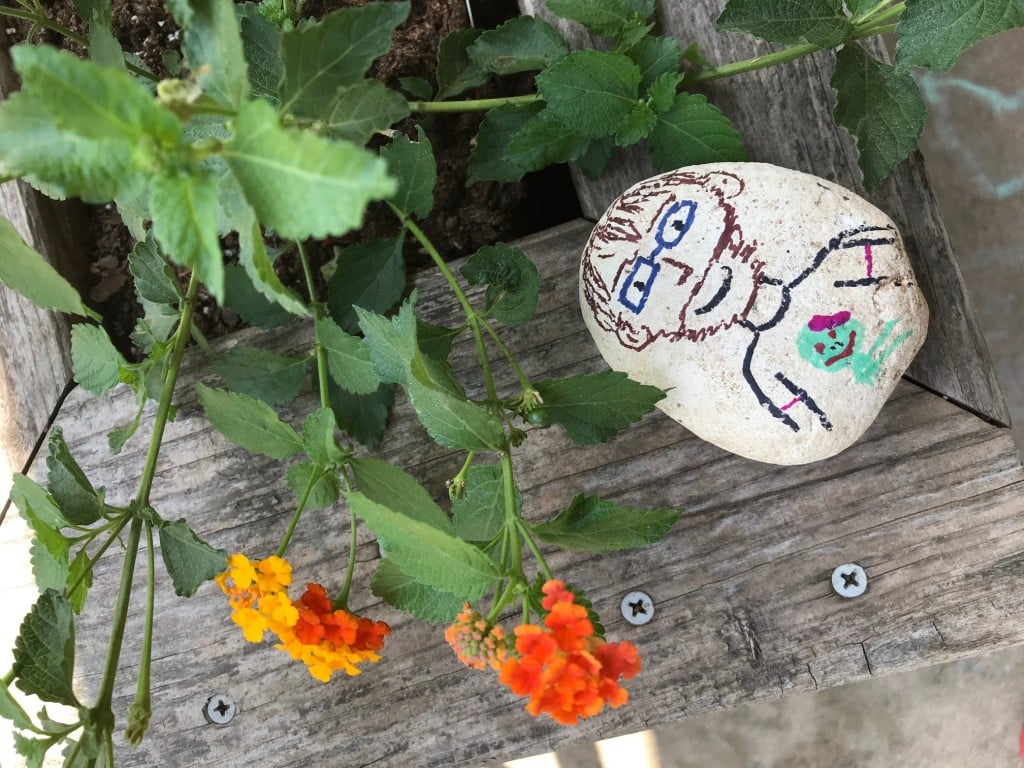 a rock with a portrait of a dad drawn on it. from our list of father's day gifts