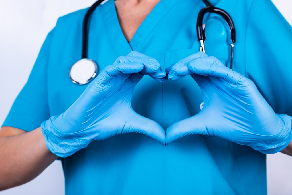 Doctor Hands In Gloves Making Heart Shape