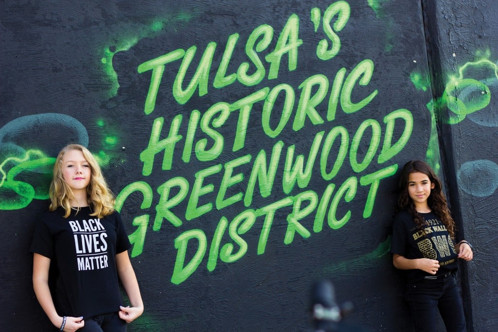 joplin and harper keidel stand in front of a mural reading tulsas historic greenwood district, for article on jop's chops