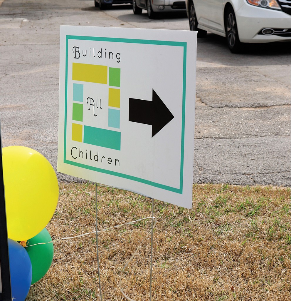 sign pointing to building all children
