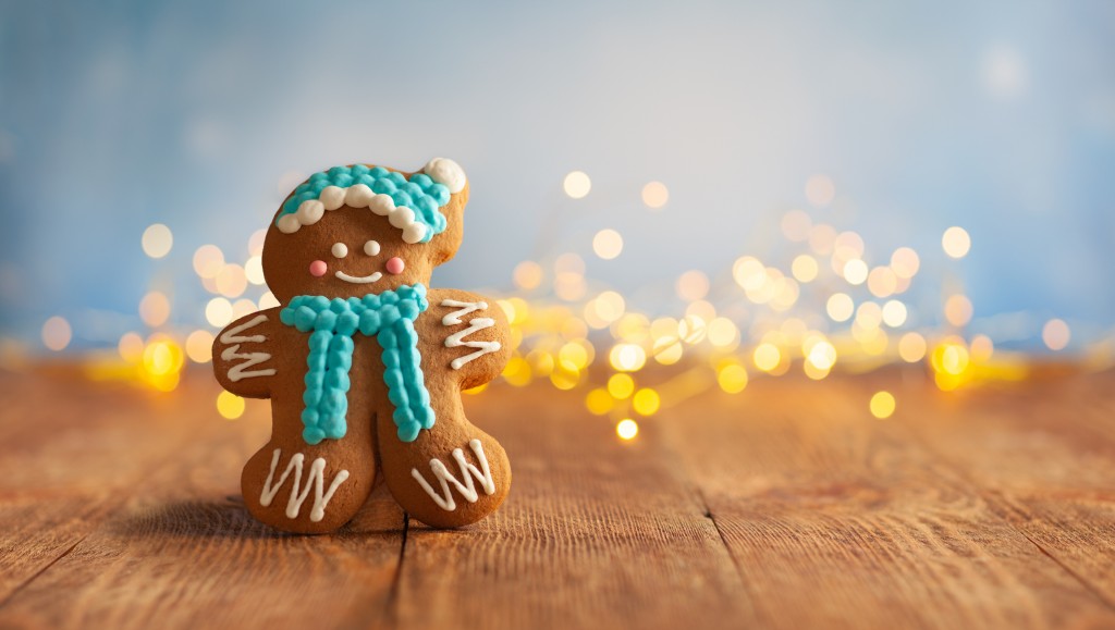 a gingerbread cookie dressed in scarf and hat, for article on easy christmas cookie recipes