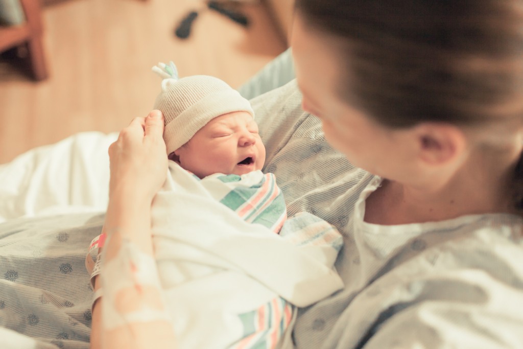 Mother Holding Her Newborn Baby At The Hospital