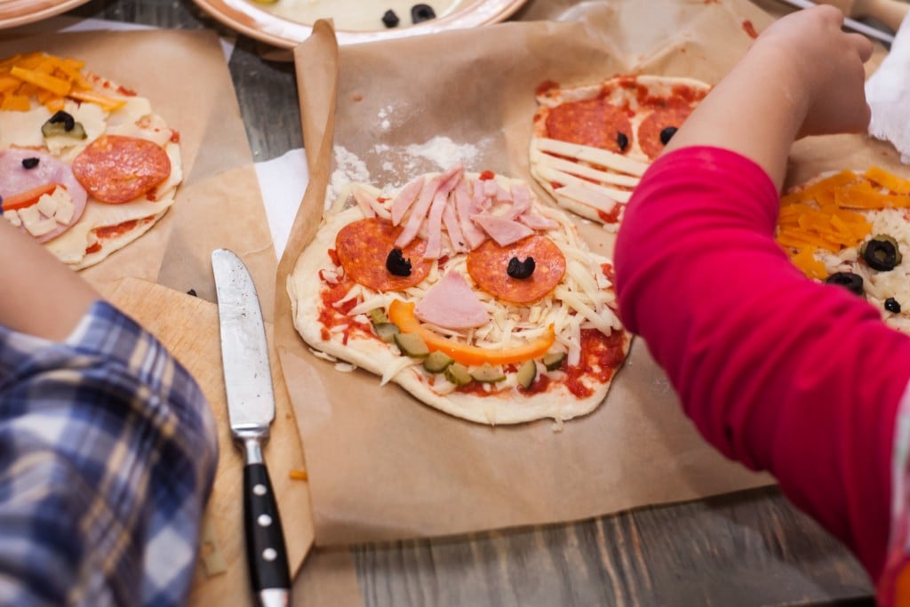 Master Class For Children On Baking Funny Halloween Pizza. Young Children Learn To Cook A Funny Monster Pizza. Kids Preparing Homemade Piizza. Little Cook.