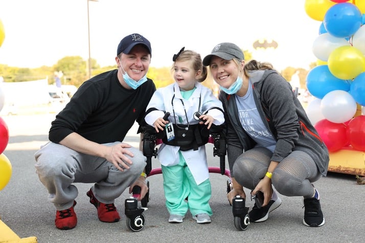 lincoln, who has cerebral palsy, with her parents