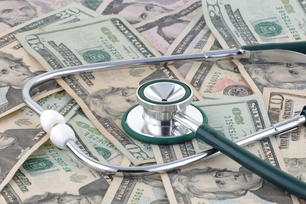 stethoscope resting on pile of money, for article on native american health care