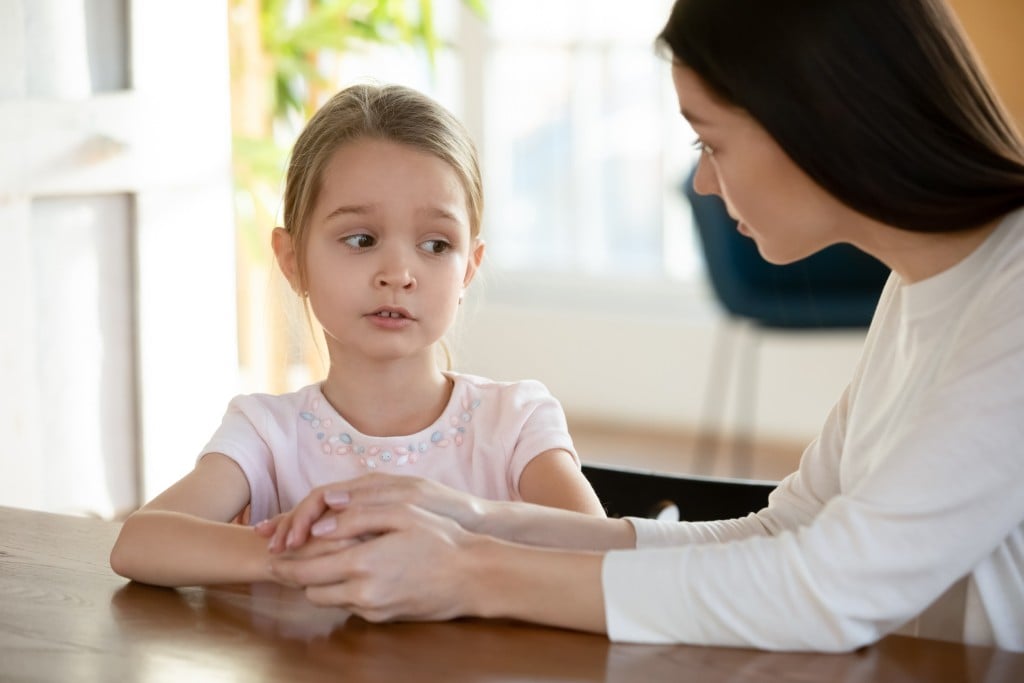 unhappy girl talks to mom, for article on what to do when children lie