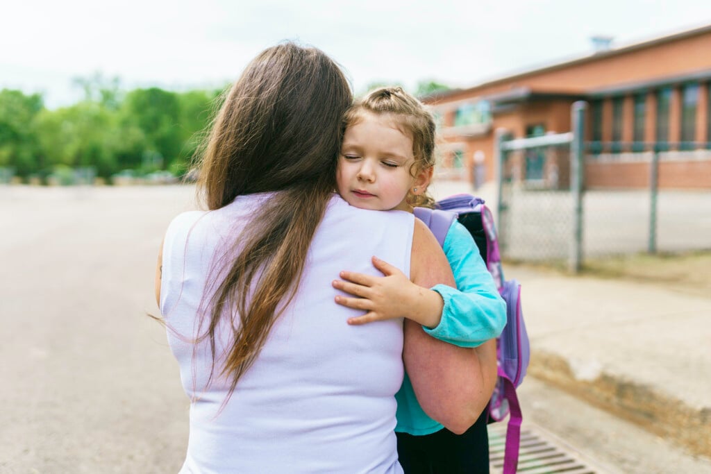 mother hugging a young girl experiencing separation anxiety