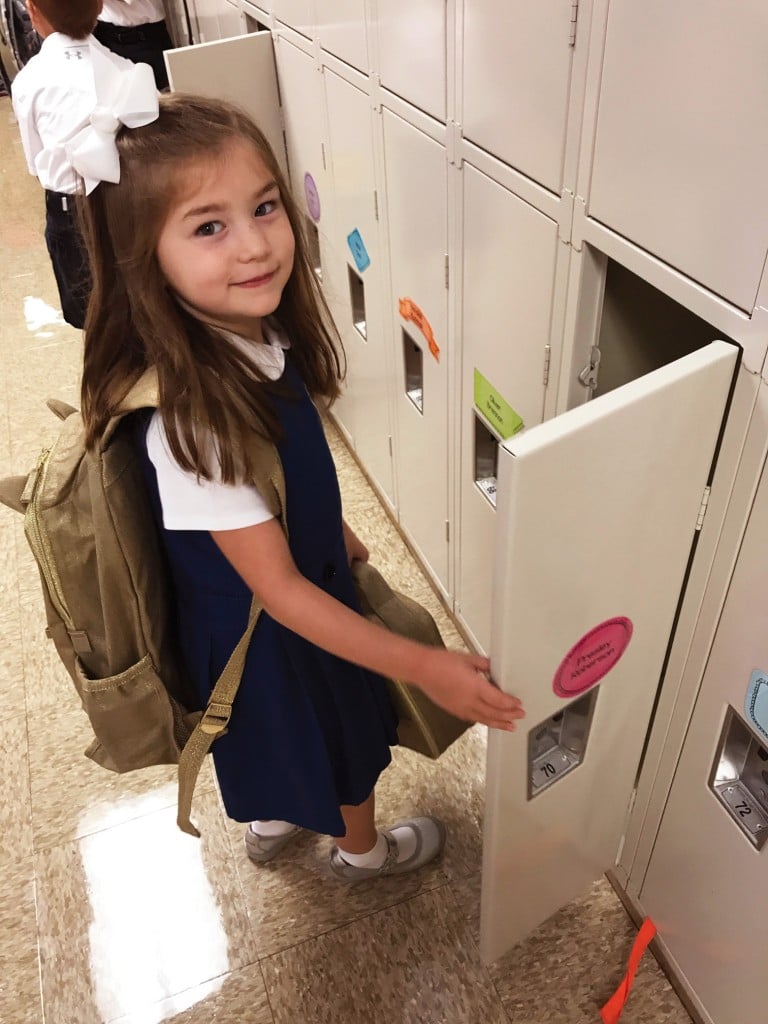 young girl opening locker. separation anxiety concept